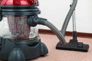 Black And Red Canister Vacuum Cleaner On Floor